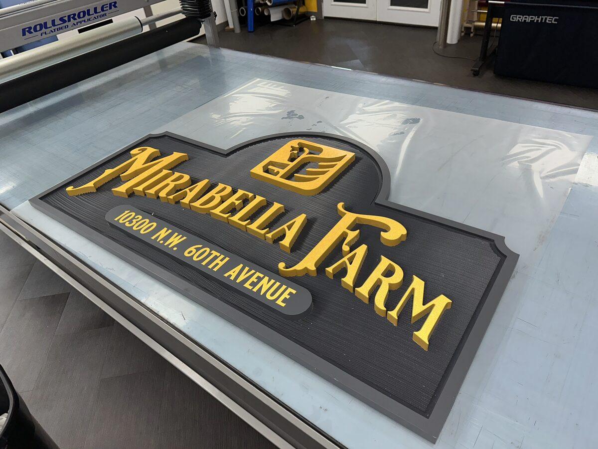 Carved HDU sign with textured background and reflective vinyl accents — CG Signs